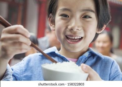 Portrait Of Little Girl Eating Rice