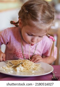 Portrait Of A Little Girl Eating Spaghetti With A Fork