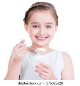 Portrait of a little girl eating yogurt - isolated on white.