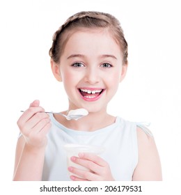 Portrait of a little girl eating yogurt - isolated on white.