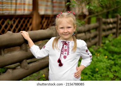 Portrait Of A Little Girl With Flowers In A Ukrainian Embroidered Shirt. . Red Berries Of Viburnum In Hair. Ukrainian Culture And Tradition. 