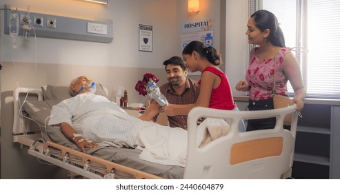 Portrait of a Little Girl and Her Mother Visiting her Grandfather who is Resting in a Hospital Bed. Family United and Showing Moral Support to an Elderly Member After Surgery - Powered by Shutterstock