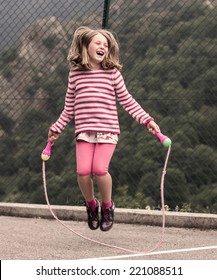 Portrait of a little girl jumping rope