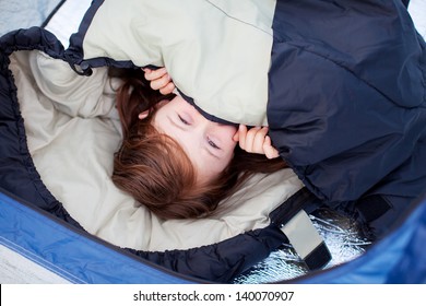 Portrait Of Little Girl Lying In Sleeping Bag