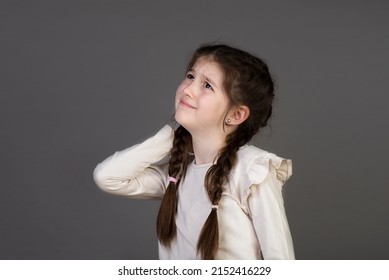 Portrait Of Little Girl Massaging Painful Back, Feel Discomfort In Neck, Child Sedentary Lifestyle.