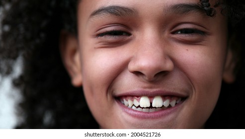 Portrait little girl smiling and laughing. African descent child face close-up - Shutterstock ID 2004521726