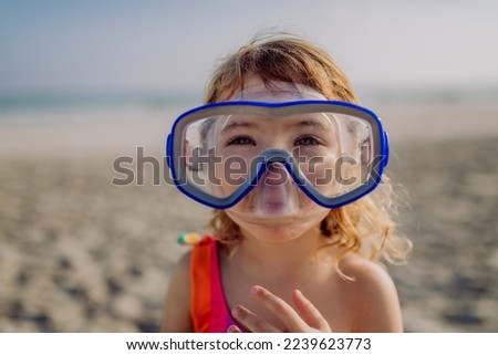 Portrait of little girl in snorkeling mask.