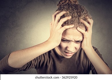 Portrait of little girl suffering from headache and holding hands on her head.Stressed little girl having problems. - Powered by Shutterstock