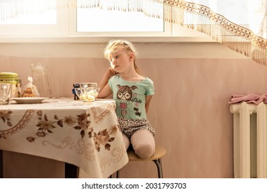 Portrait Of A Little Girl Toddler At The Dining Table. Poor Appetite.