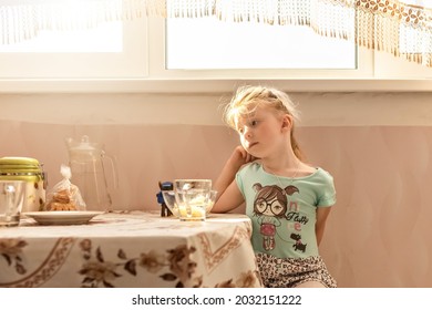 Portrait Of A Little Girl Toddler At The Dining Table. Poor Appetite.