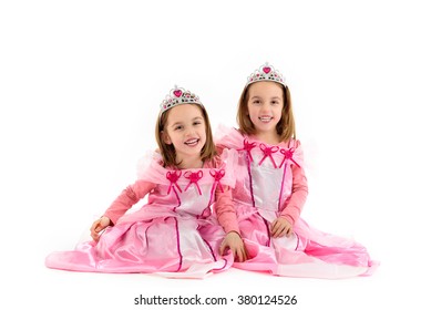 Portrait of Little identical twins Girls dressed as princess in pink. Happy children ready for costume party. Cute smiling joyful twins are wearing royalty costume of princess or queen. - Powered by Shutterstock