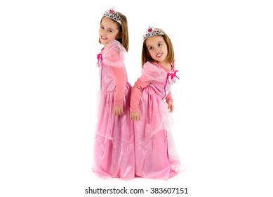 Portrait of Little identical twins Girls dressed as princess in pink. Happy children ready for costume party. Cute smiling joyful twins are wearing royalty costume of princess or queen. - Powered by Shutterstock