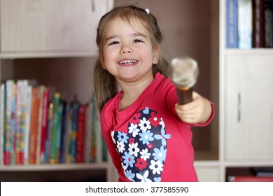 Portrait Of Little Kid Singing Into Microphone And Proposing To Sing To The Audience, Entertainment And Education Concept, Indoor