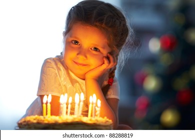 Portrait of little pretty girl with birthday cake