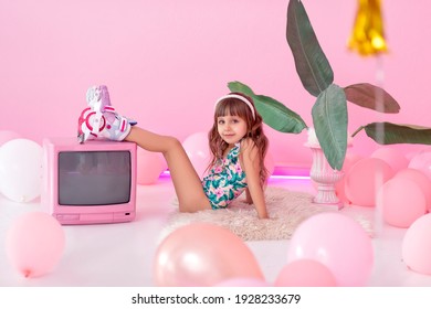 Portrait of a little roller-girl  with  retro TV
