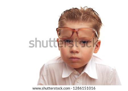 Portrait of a little serious boy in a funny glasses and white shirt. Preschool child, place for text