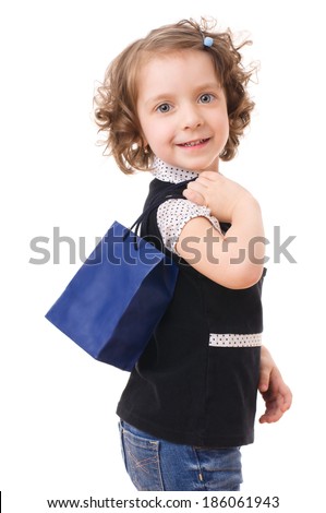 Portrait of a little shopping girl with shopping bags, isolated over white