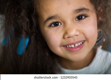 portrait of a little swarthy girl with beautiful eyes and a cute smile