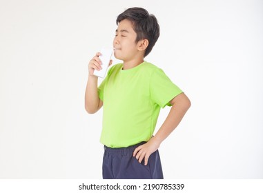 Portrait Of A Little Young Handsome Kid Boy In Green Shirt, Hold Drinking Milk Box Mockup, Isolated On White Background. Concept Of Happy Good Nutrition