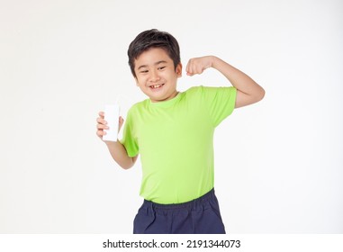 Portrait Of A Little Young Handsome Kid Boy In Green Shirt, Hold Drinking Milk Box Mockup, Isolated On White Background. Concept Of Happy Good Nutrition