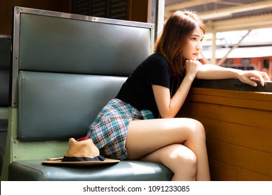 Portrait loneliness beautiful woman. Charming beautiful girl feels lonely and looking outside the train window. Pretty girl gets homesick and miss her family during she goes to a city for working