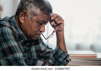 Portrait Of Lonely Elderly Asian Man In His 60s Sitting At Home, Sad, Depressed, Alone.