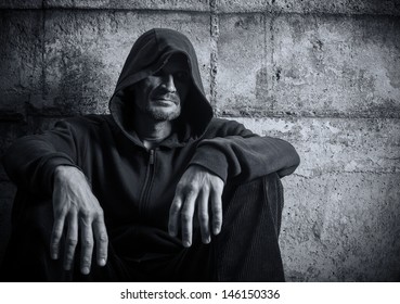 Portrait of a lonely man in a hood