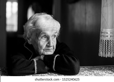 Portrait Of A Lonely Sad Old Lady. Black And White Photo.