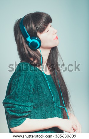 Similar – Young blonde woman listening to music with her headphones