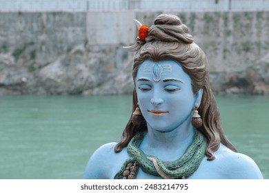Portrait of Lord Shiva meditating on the banks of the Ganges in Rishikesh, India. - Powered by Shutterstock