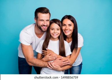 Portrait of lovely adult guy woman and cute kid hug piggyback wearing white t-shirt denim jeans isolated over blue background