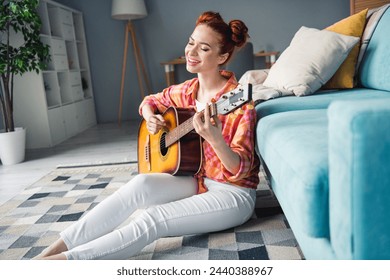 Portrait of lovely cheerful female person sit floor sing play guitar weekend morning spacious flat inside - Powered by Shutterstock