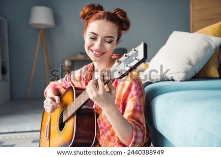 Portrait of lovely cheerful young lady beaming smile playing guitar weekend serenity modern house indoors