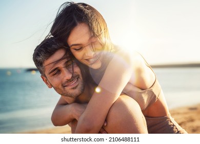 Portrait of lovely couple in love having fun on the beach. Young beautiful people hugging . Romantic moment. Valentine's day. Honey moon.