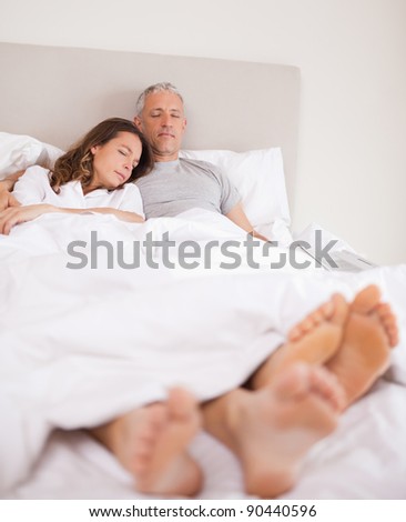 Portrait of a lovely couple sleeping in their bedroom