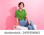 Portrait of lovely creative person sit podium look interested empty space imagine isolated on pink color background