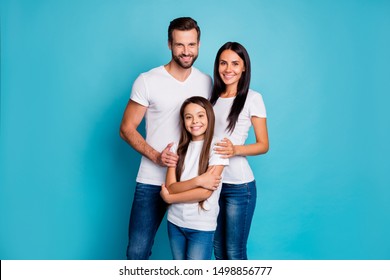 Portrait Of Lovely Family Looking With Toothy Smile Wearing White T-shirt Denim Jeans Isolated Over Blue Background