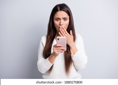 Portrait Of Lovely Focused Worried Brown-haired Girl Using Device Reading Bad News Comment Isolated Over Grey Pastel Color Background