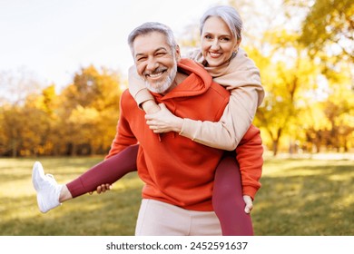 Portrait of lovely happy elderly couple on morning run outside in city park, retirees wife and husband rejoice in active lifestyle, smiling woman tenderly embracing her spouse after routine jogging - Powered by Shutterstock