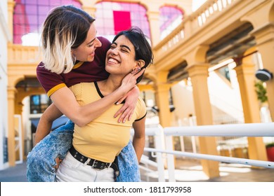 Portrait of lovely lesbian couple spending time together and having fun at the street. LGBT concept. - Powered by Shutterstock