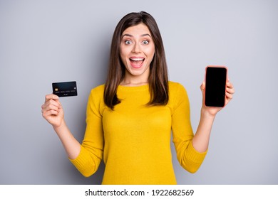 Portrait of lovely lucky amazed glad cheerful girl holding in hands gadget bank card good solution isolated over grey color background - Shutterstock ID 1922682569