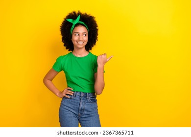 Portrait of lovely positive person beaming smile look indicate finger empty space offer isolated on yellow color background - Shutterstock ID 2367365711