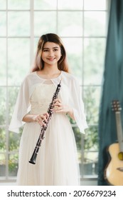 Portrait Of A Lovely Woman Playing The Transverse Flute. Beautiful Asian Female Artists, Classical Musicians