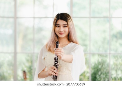 Portrait Of A Lovely Woman Playing The Transverse Flute. Beautiful Asian Female Artists, Classical Musicians