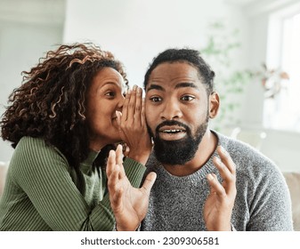 Portrait of a lovely young couple having fun and laughing together at home, Young  black woman sharing secrets with her excited boyfriend - Powered by Shutterstock