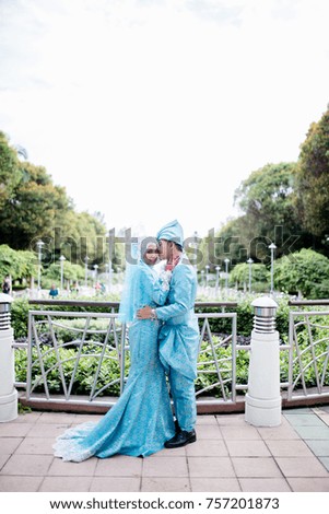 Portrait of lovely young couple hugging and holding hand at park. Love story, marriage and wedding concept. Selective focus
