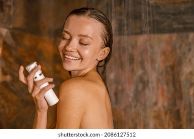 Portrait of lovely young woman standing in marble shower and washing her body using organic natural body care cosmetics. Spa and beauty concept - Powered by Shutterstock