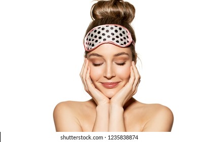 Portrait Of Lovely Young Woman Wearing Sleeping Mask And Kindly Smiling. Beauty And Skincare Concept. Naturally Beautiful Girl Posing On White Background