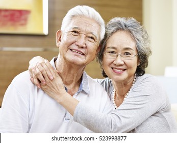 Portrait Of A Loving Asian Couple, Looking At Camera Smiling