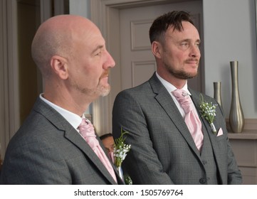 Portrait Of A Loving Gay Male Couple On Their Wedding Day.